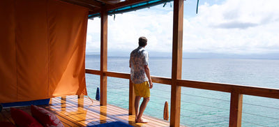 Man in boardshorts looking out to sea